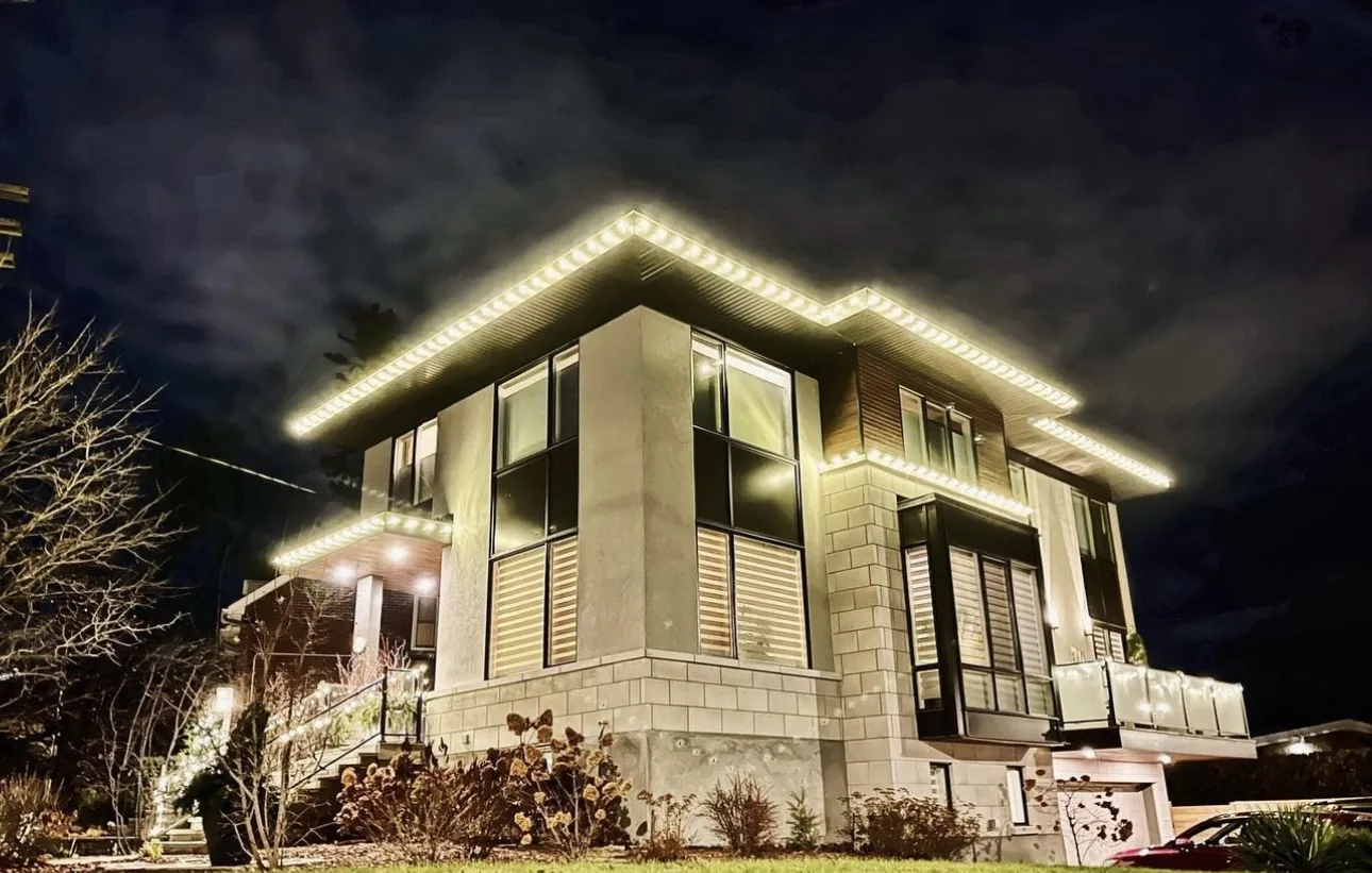 Evening view of a home with warm white lighting along the roof edges